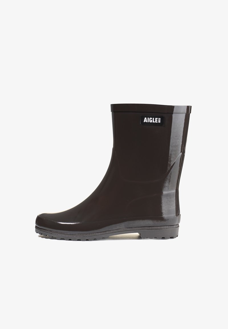 Botte de pluie en caoutchouc marron avec une finition brillante, hauteur cheville, semelle texturée pour une bonne adhérence et un petit logo sur le côté.