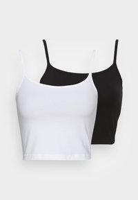 Dois tops de alças cortados, um branco e um preto, feitos de algodão suave. Cada um apresenta alças finas e um design simples e sem costuras.