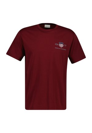 Bordeauxrotes Baumwoll-T-Shirt mit einem Frontlogo, das "GANT" und "AMERICAN SPORTSWEAR" zeigt. Klassisches Rundhalsdesign mit kurzen Ärmeln.