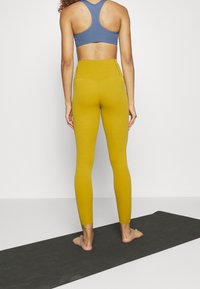 Nike Performance Leggings - dark yellow