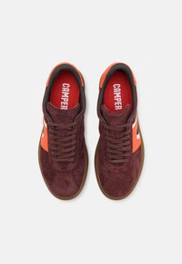 Burgundi suede tossud oranžide aksentidega, ümmargune varvas, nööridega kinnitamine ja kontrastne tumepruun kummitald. Selge brändimine sisetallal.