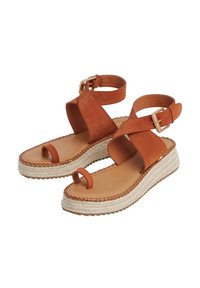 Smeđe suede espadrile sandale s širokim dizajnom križnog remena, remenom oko gležnja, kopčom i pletivom od juta. Stil s otvorenim prstima.