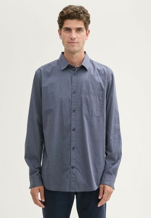 Long-sleeve, navy blue button-up shirt with subtle texture, a chest pocket, and a classic collar, made from a lightweight fabric.