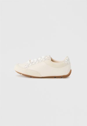 White leather sneaker with patterned textile accents, rounded toe, lace-up front, and rubber sole, featuring subtle branding on the side.