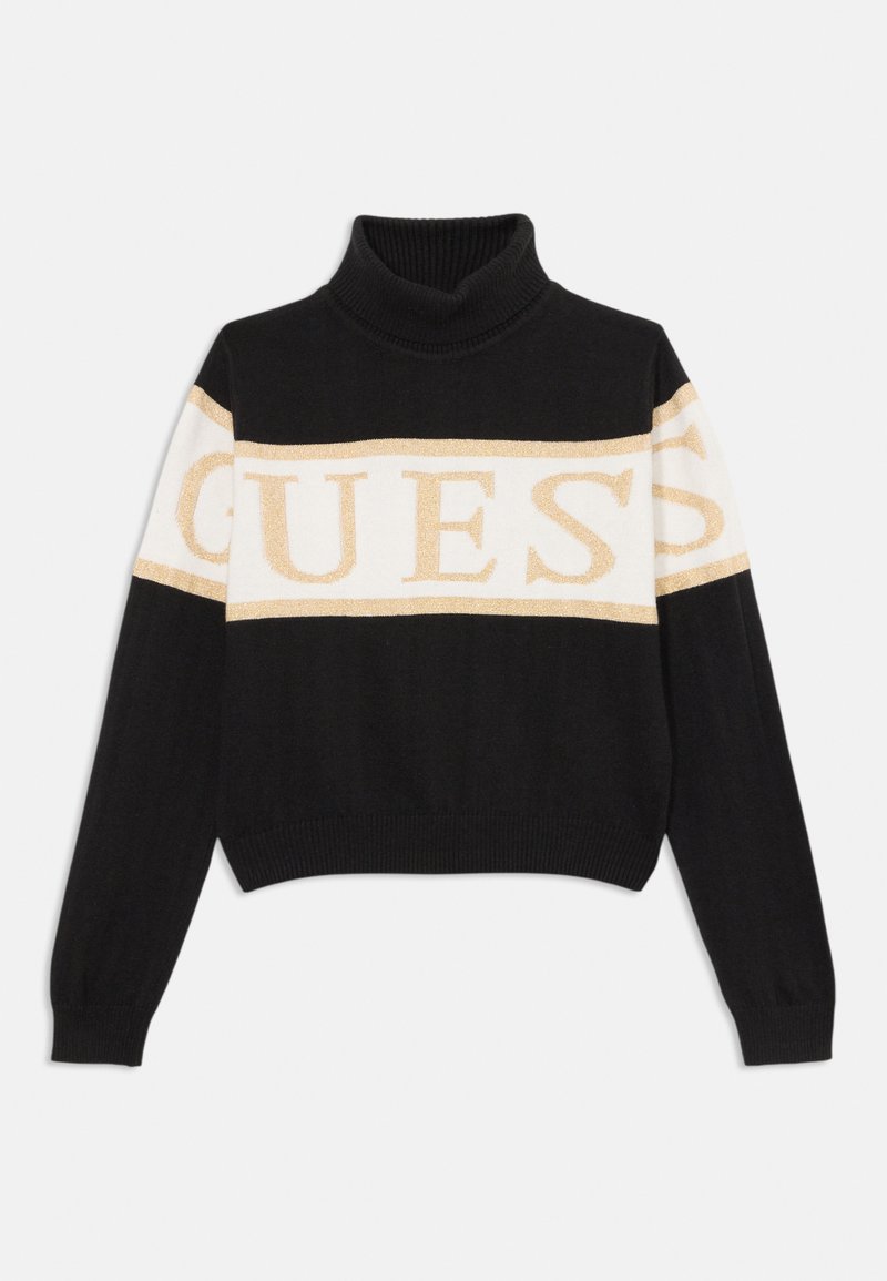 Črn skrajšan pulover s turtleneck ovratnikom, ki ima zlate in bele "GUESS" logotipe na prsih ter rebraste manšete. Mehak pleten material.