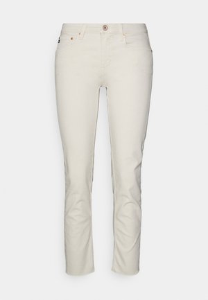 Gaiši beigi ankle garuma džinsi, izgatavoti no kokvilnas ar gludu tekstūru, piecu kabatu dizains un metāla pogas aizdare.