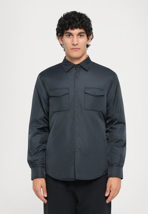 Black, long-sleeve shirt made of smooth, lightweight material. Features button-up front, two chest pockets, and a classic collar design.