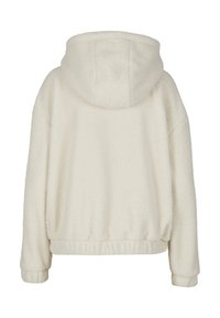Hoodie en polaire crème avec une texture douce, coupe surdimensionnée et poche kangourou à l'avant. Il dispose d'une capuche ajustable et de poignets ribbed.