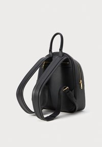 Black textured leather backpack with double adjustable straps, top handle, and gold zipper details on a plain white background.