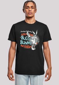 Svart bomull t-skjorte med et fargerikt grafikk av Bugs Bunny med teksten "Vintage Collection" og "Original Bugs Bunny" i fet skrift.