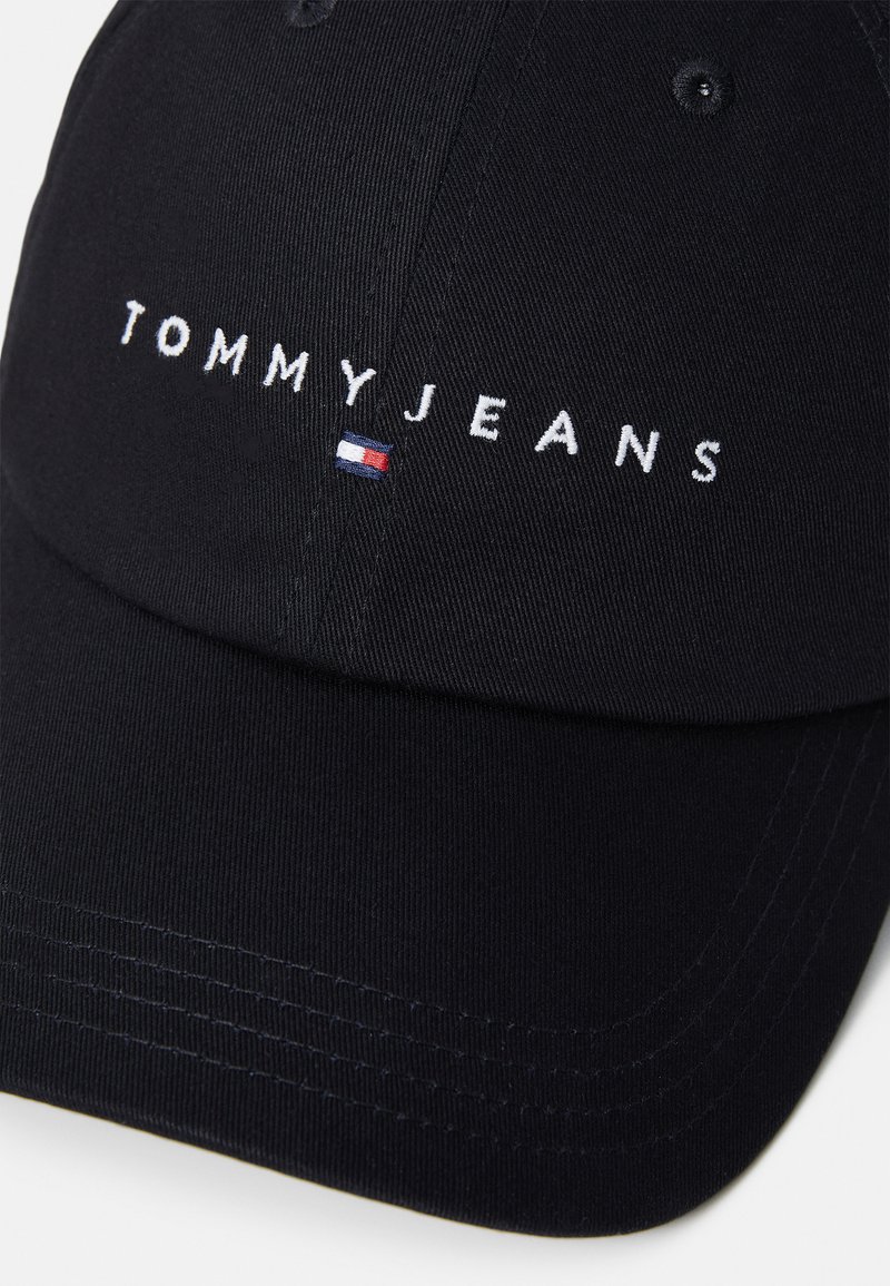 Czarna czapka bejsbolowa z haftowanym logo "TOMMYJEANS" z przodu i małym akcentem w postaci flagi; wykonana z gładkiego materiału o sztywnej konstrukcji.