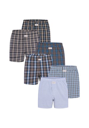 Sei paia di boxer da uomo a quadri e a righe disposti in due file con vari motivi blu, neri e grigi.