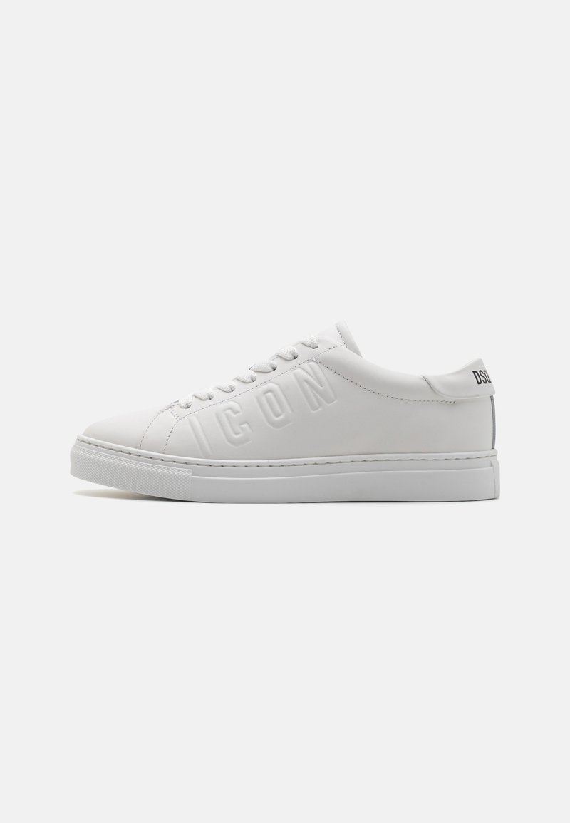 White leather sneakers with a round toe, embossed "ICON" lettering on the side, and a textured rubber sole. Minimalist design with a smooth finish.
