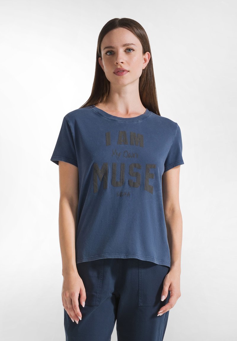 Camiseta de algodón de manga corta en color azul marino, con un audaz texto en negro "SOY MI PROPIO MUSE" en la parte frontal. Cuello redondo clásico, corte relajado.