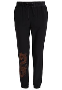 Black sweatpants with a drawstring waistband, elastic cuffs, and a prominent orange dragon print on the left leg. Smooth fabric texture.