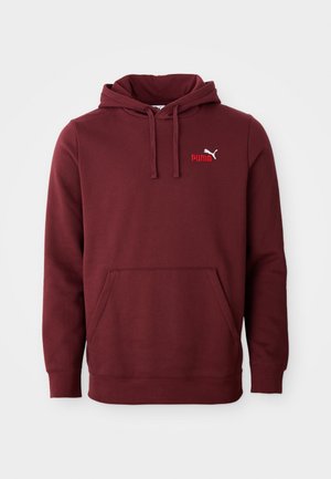 Hoodie Puma bordeaux avec poche kangourou à l'avant, capuche réglable avec cordon de serrage et petit logo Puma sur la poitrine gauche.