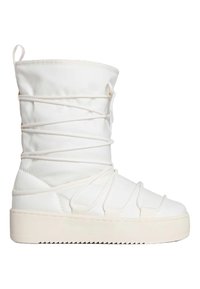Stivale bianco imbottito con gambale alto, caratterizzato da cinghie elastiche incrociate e una suola platform spessa e texturizzata. Tessuto morbido e dettagli di accento.