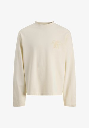 Cream-colored long-sleeve crewneck shirt with subtle beige logo text on the upper left chest, plain front and regular fit.