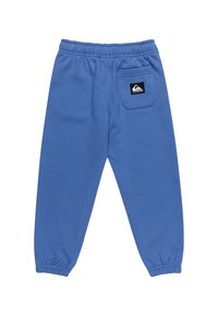 Blauwe joggers met een elastische tailleband, taps toelopende boorden en een achterzak met een zwart logo patch. Gemaakt van zachte katoenmix.