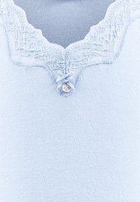 Light blue sweater featuring a scalloped lace neckline, a rounded V-shape, textured fabric with heart patterns, and a single decorative button.
