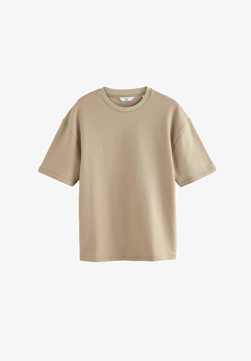 T-shirt beige a maniche corte realizzato in morbido cotone. Presenta un collo rotondo e una vestibilità comoda con cuciture visibili. Texture liscia, design minimale.