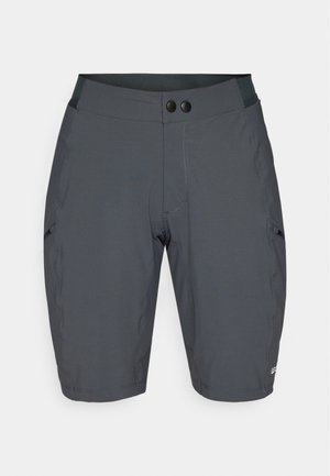 Sötétszürke nadrág, sima és rugalmas anyagból. Széles derékrésszel rendelkezik, két fekete gombbal és ferde oldalzsebekkel.