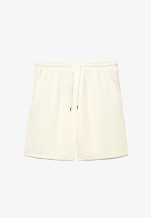 Pantaloncini in tessuto di colore bianco sporco con texture, dotati di cintura elastica, coulisse e tasche laterali, distesi su uno sfondo bianco.