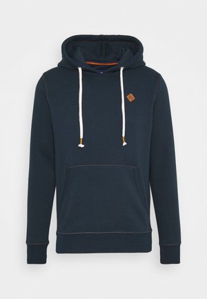 Sudadera azul marino con bolsillo frontal, cordones blancos con puntas marrones y pequeño parche de logo marrón en el pecho.