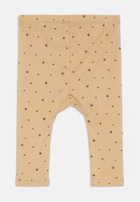 Μπεζ κολάν μωρού με διάσπαρτα μικρά και μεσαία σχέδια μαύρων αστεριών, με μαλακή ελαστική μέση και ραμμένα μανίκια.