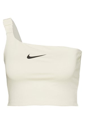 Crop top Nike blanc à une épaule avec bretelle ajustable et logo noir au centre devant.