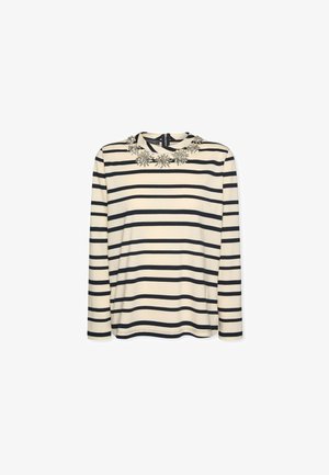 Striped long-sleeve top in cream and navy, featuring a round neckline adorned with floral embellishments at the collar. Smooth fabric texture.