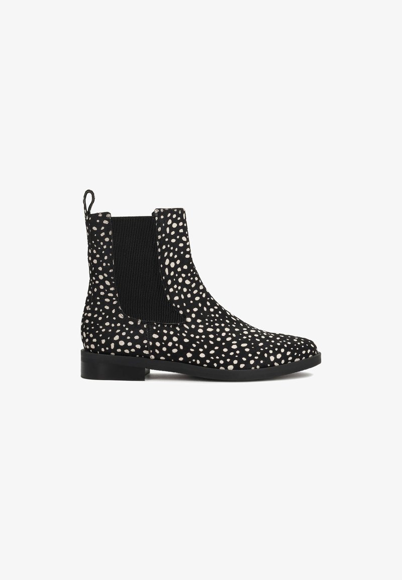 Botte Chelsea noire à pois blancs, panneau latéral élastique, talon bas et languette à l'arrière.