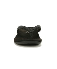 Tongs noires avec une semelle en suède texturé et une bride pailletée. Le design présente un large ligature entre les orteils et une semelle en caoutchouc flexible.