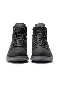 Botas de senderismo negras con parte superior de cuero liso, ojales de metal, cordones gruesos y suela de goma resistente. Presentan un diseño de tobillo alto para brindar soporte.