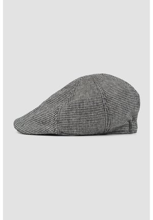 Casquette plate pied-de-poule noire et blanche avec une couronne douce et arrondie et une visière incurvée, affichée sur un fond neutre.