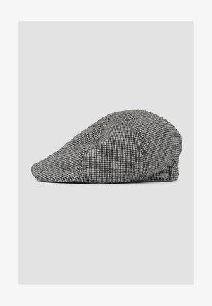Casquette plate pied-de-poule noire et blanche avec une couronne douce et arrondie et une visière incurvée, affichée sur un fond neutre.