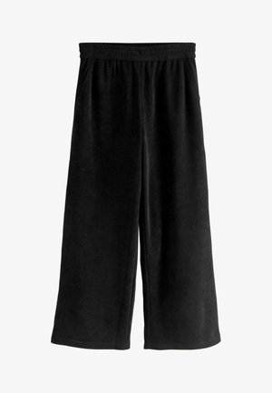 Svarta kordflortbyxor med vida ben, elastisk midja och sidofickor. Mjuk textur med vertikalt ribbat mönster, inga synliga knäppningar.