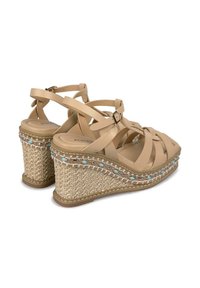 Sandali con zeppa beige caratterizzati da fasce incrociate, soletta intermedia in juta intrecciata e dettagli blu decorativi lungo il bordo. Include una fascia regolabile per la caviglia.