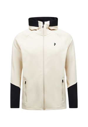 Giacca beige con zip, colletto nero e maniche inferiori nere, con tasche frontali con zip e un piccolo logo nero sul petto.