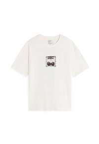 T-shirt bianco in cotone con una grafica nera centrale di bilance all'interno di un bordo decorativo. Maniche corte e scollo rotondo.