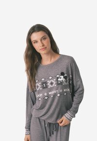 Gray long-sleeve pajama top featuring a Mickey Mouse graphic, geometric pattern, and textured cuffs. Made from soft fabric, relaxed fit.