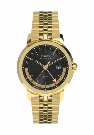 Guldtonet Timex Marlin ur med sort urskive, guld timeindekser, datovisning og et tekstureret guld armbånd.