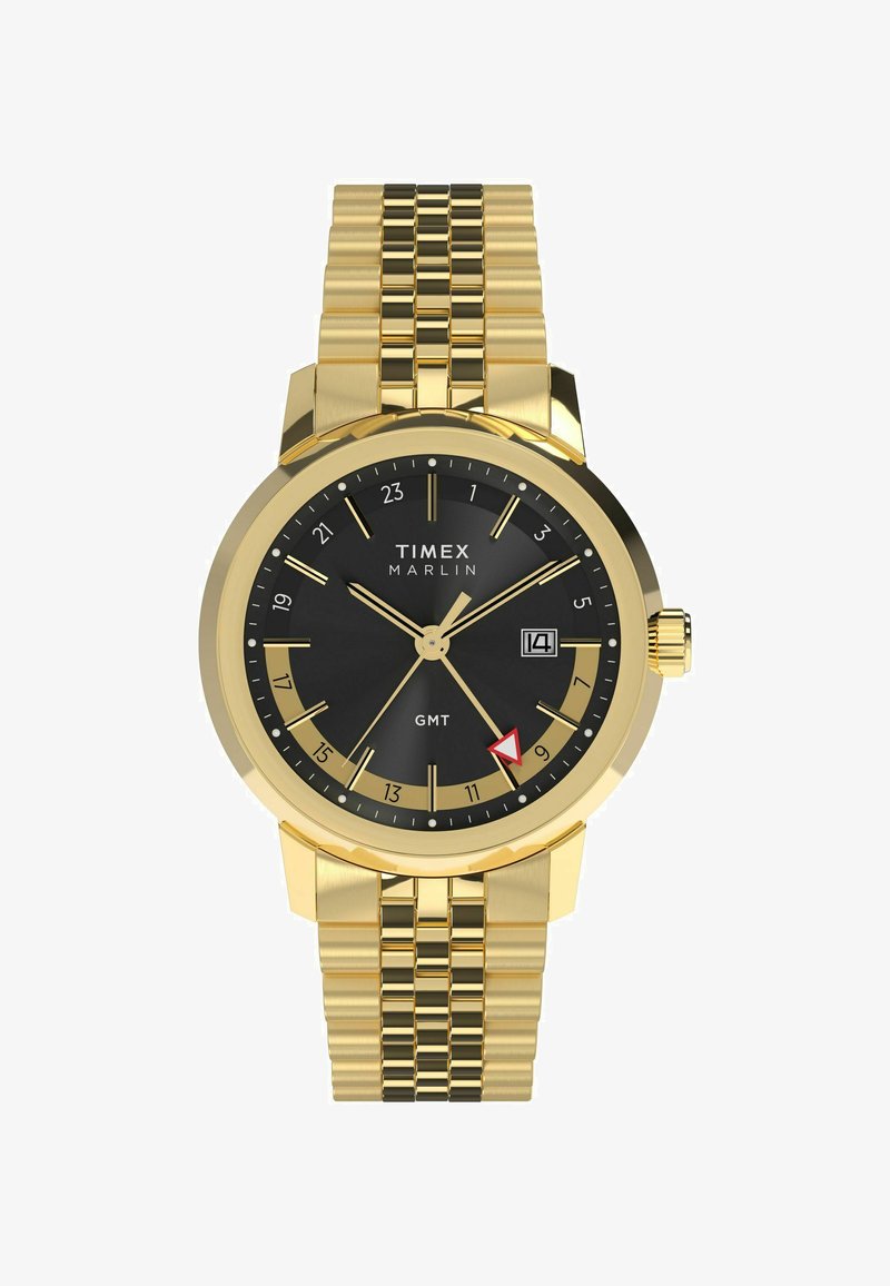 Arany színű Timex Marlin óra fekete számlappal, arany órajelzőkkel, dátum kijelzővel és textúrázott arany karkötőszíjjal.
