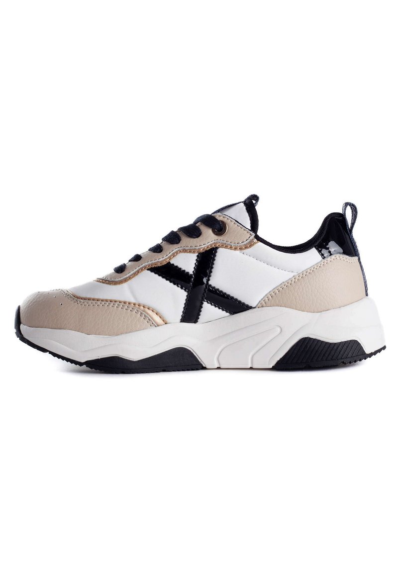 Sneakers with a white, beige, and black color scheme, featuring a textured leather upper, a chunky sole, and contrasting accents.