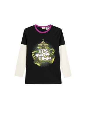 T-shirt noir à manches longues avec des manches blanches, présentant un motif graphique en vert et violet avec la mention "C'est l'heure du spectacle!" dans un design inspiré du cirque.