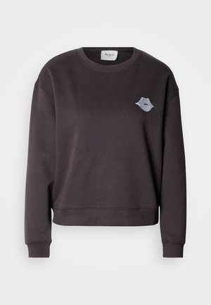 Temno siva jopa z okroglim izrezom in dolgimi rokavi, s subtilnim vezenim dizajnom ustnic na levi strani prsnega koša. Mehka tekstura.