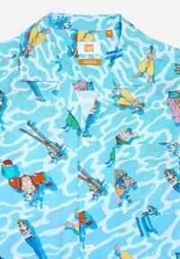 Short-sleeve shirt with a light blue, wavy pattern featuring colorful cartoon characters. Soft fabric with a relaxed fit and front pocket.
