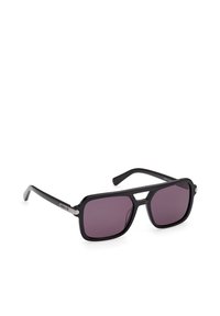 Lunettes de soleil rectangulaires noires avec verres violet foncé, monture épaisse et logo Adidas sur les branches, présentées sur fond blanc.