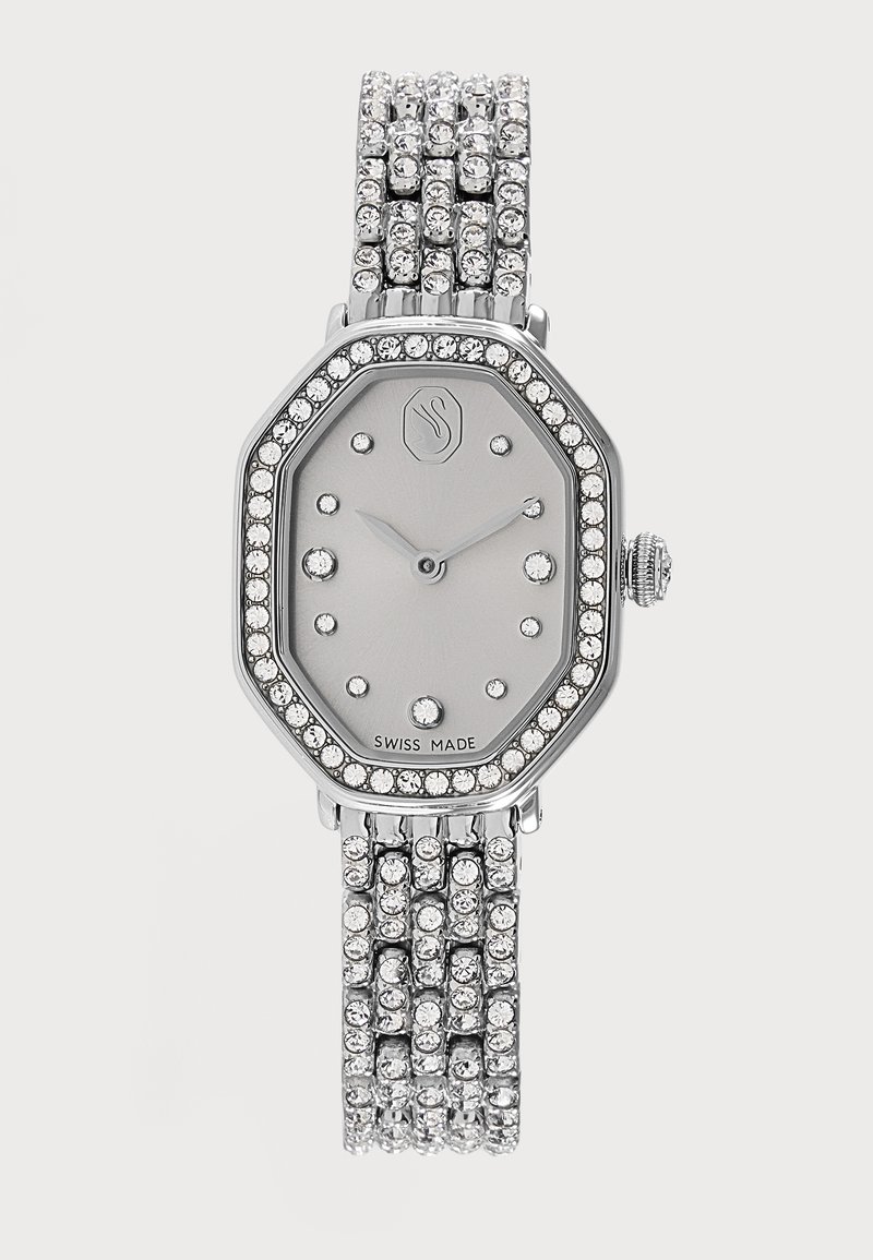 Montre-bracelet argentée à cadran octogonal, index et lunette en cristal, et bracelet orné de plusieurs rangées de cristaux, fabrication suisse.