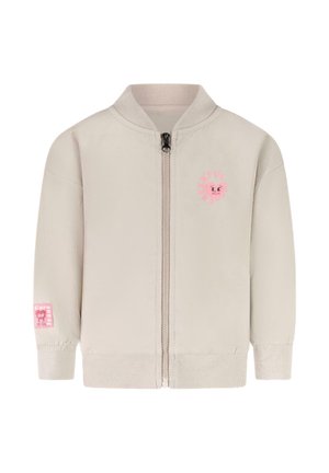 Lichtbeige ritsjack met een geribde kraag en manchetten. Heeft een roze glimlachend gezichtlogo op de borst en een roze label op de mouw.